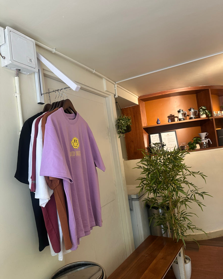 CAD tees on a wall-mounted rail beside the brew bar at Midori Matcha Bar, Bangalore